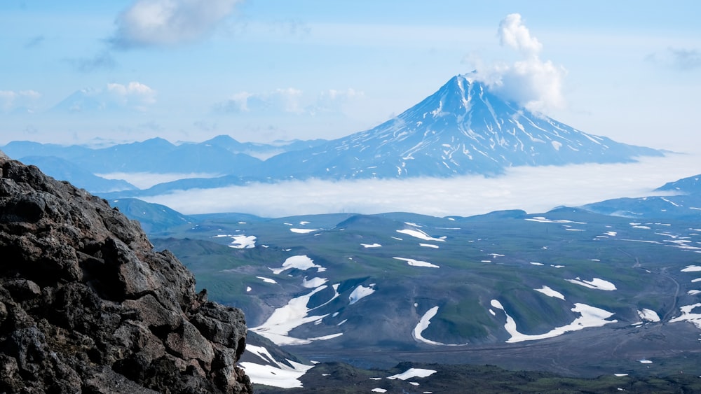 snow covered mountain under cloudy sky during daytime