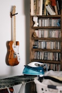 brown and white electric guitar on brown wooden shelf