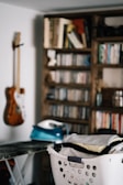 brown acoustic guitar on brown wooden shelf