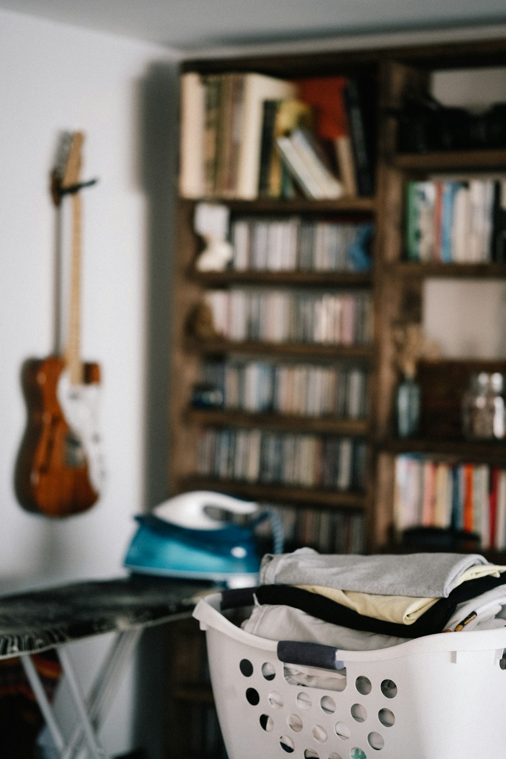 brown acoustic guitar on brown wooden shelf