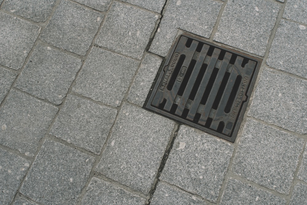 black metal door mat on gray concrete floor