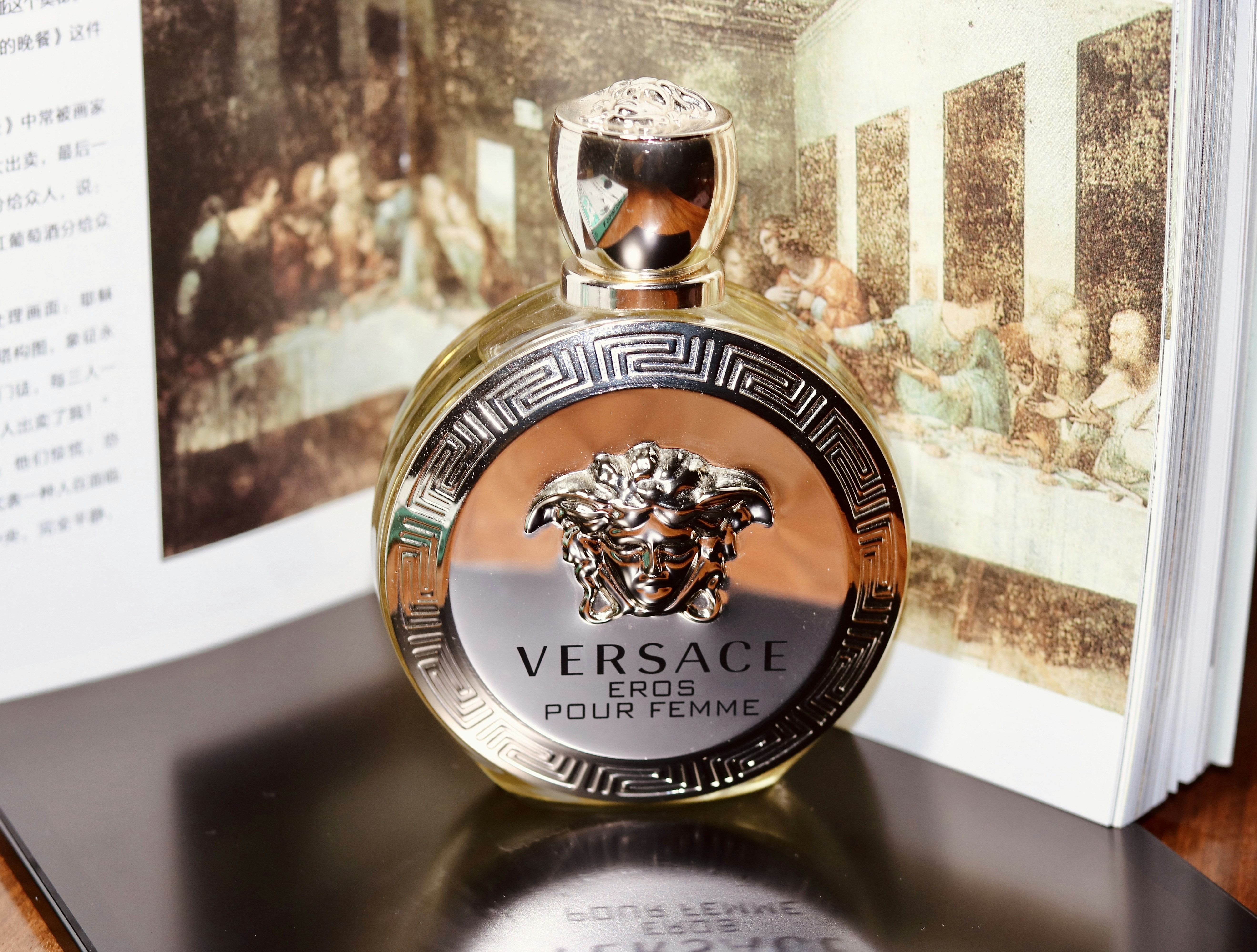 a close up of a bottle of perfume on a table