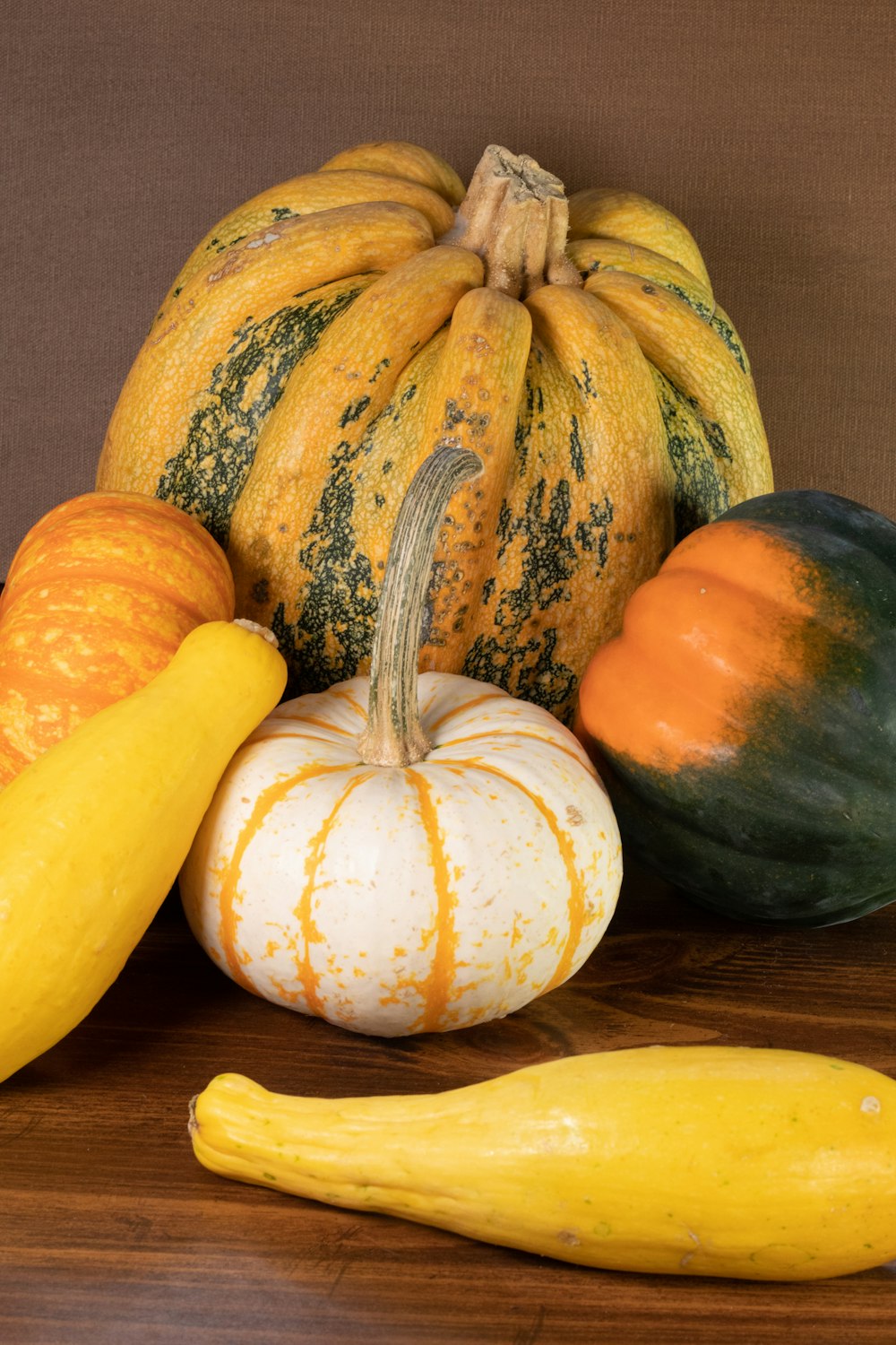 yellow and green pumpkin on brown wooden table