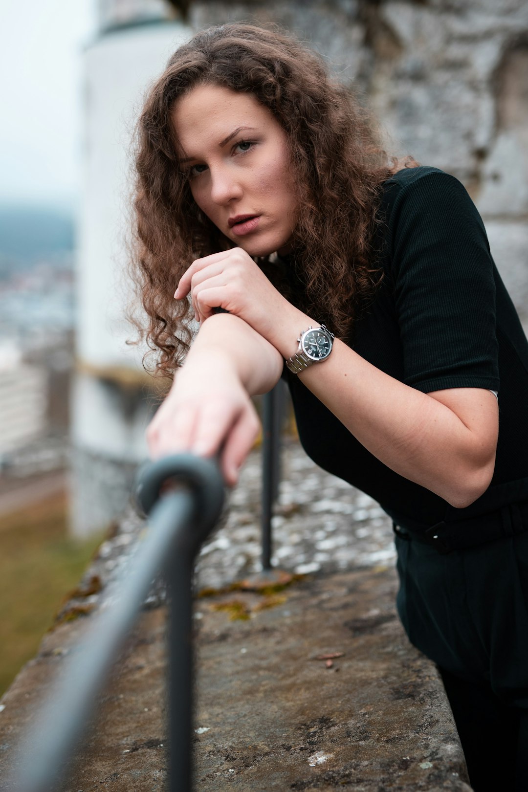 woman in black shirt leaning on railings