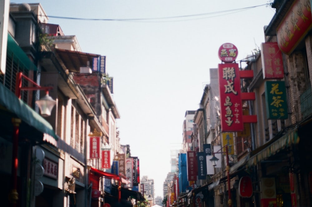 people walking on street between buildings during daytime