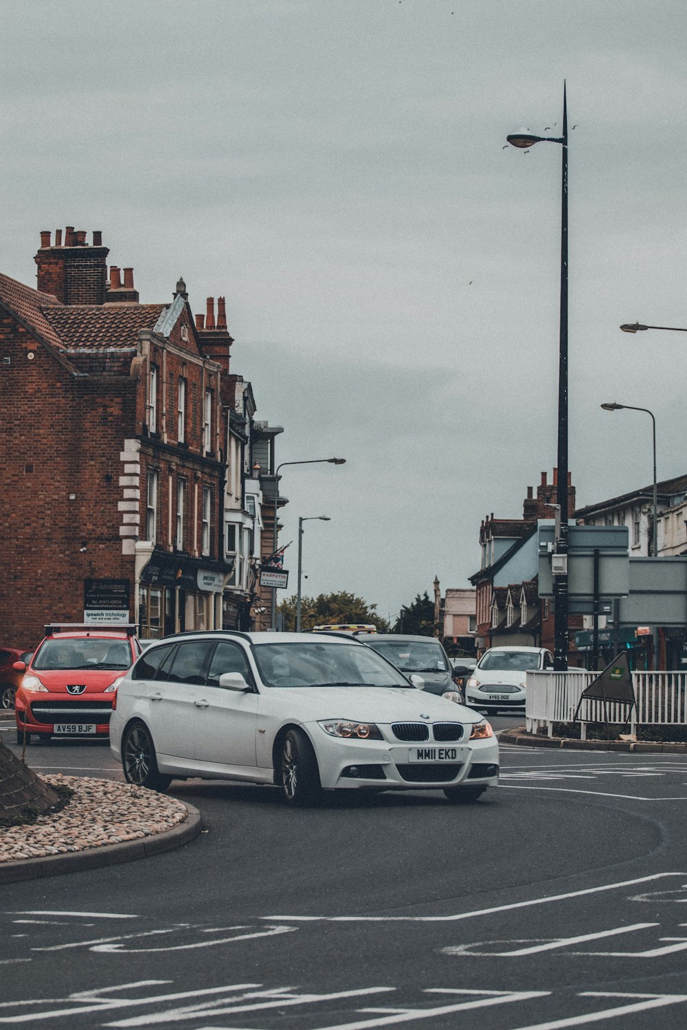 white sedan on road during daytime