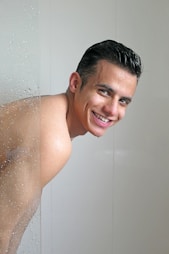 topless woman in white ceramic bathtub
