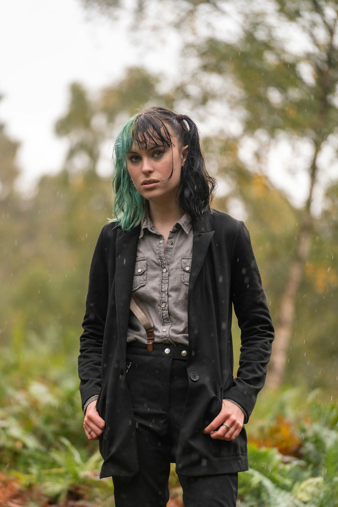 woman in black jacket standing on green grass field during daytime