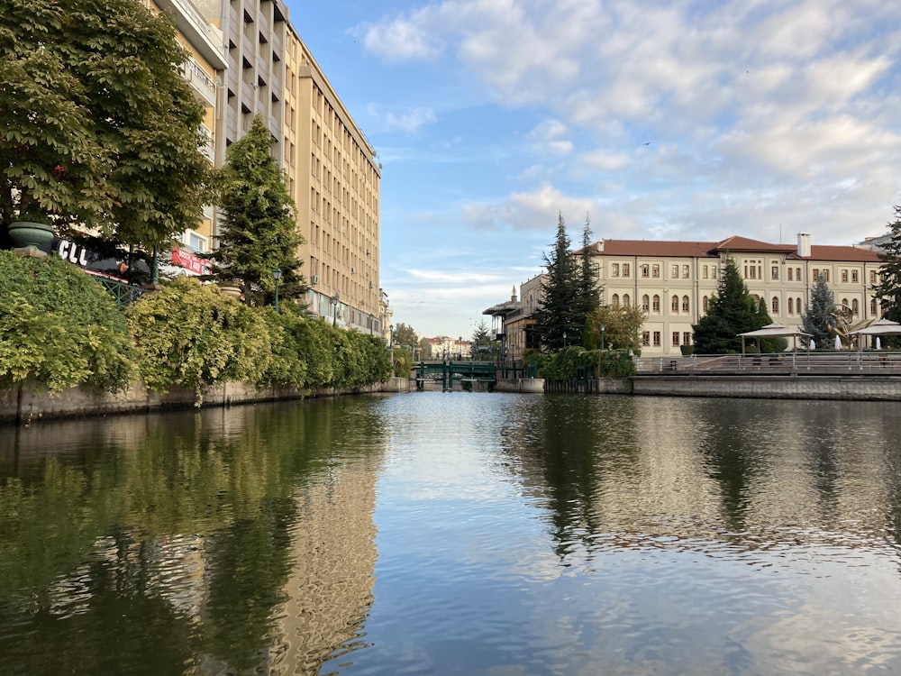 brown concrete building near river under blue sky during daytime