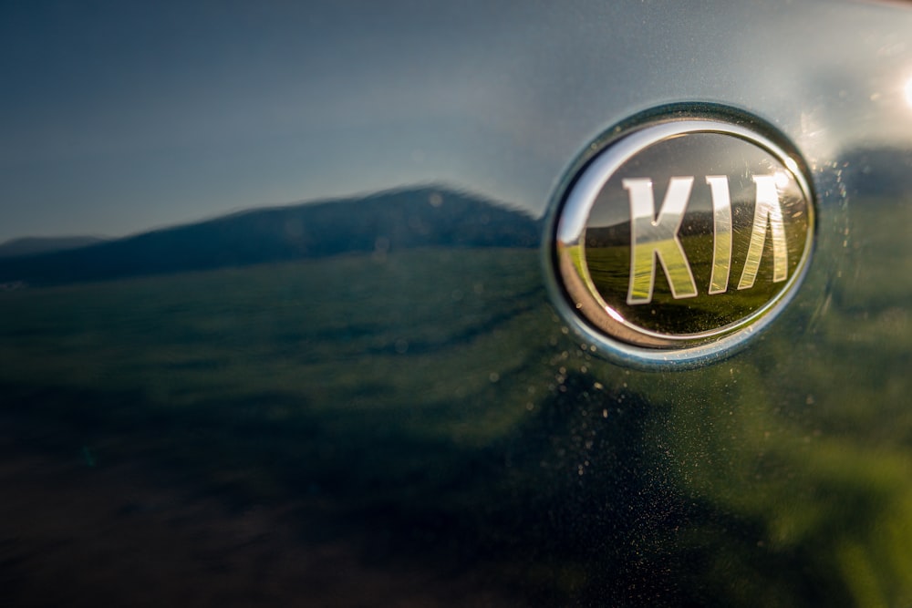 A Kia Emblem on a Red Vehicle · Free Stock Photo