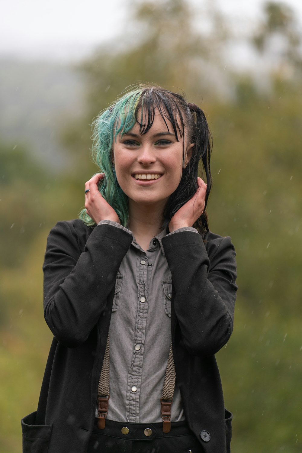 woman in black jacket with blue hair