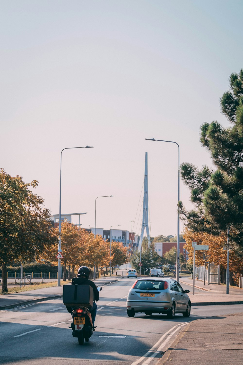 man in black jacket standing near black car during daytime