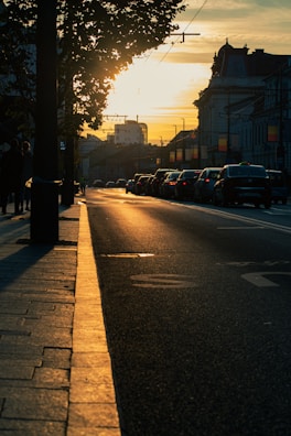 Sunset casting warm light on a freshly paved street.