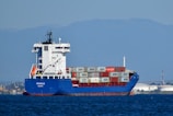 blue and white cargo ship on sea during daytime