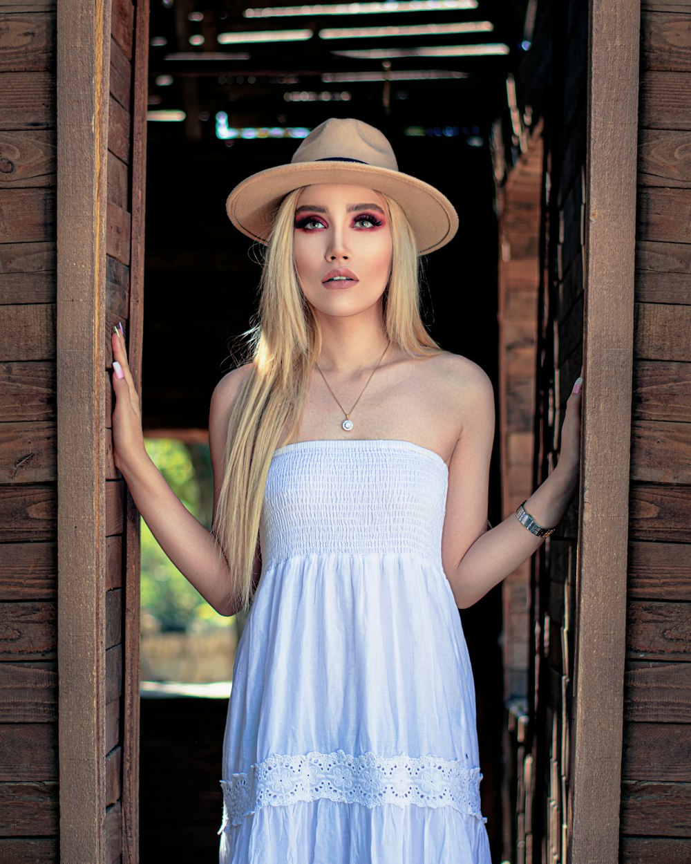 woman in blue tube dress wearing brown hat