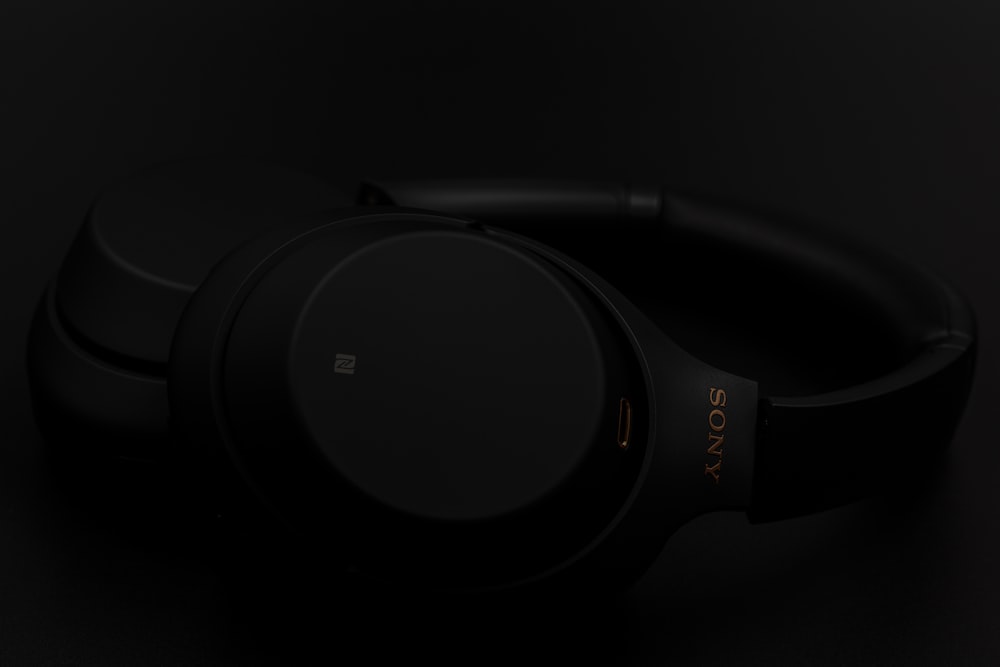 black and gray headphones on white surface