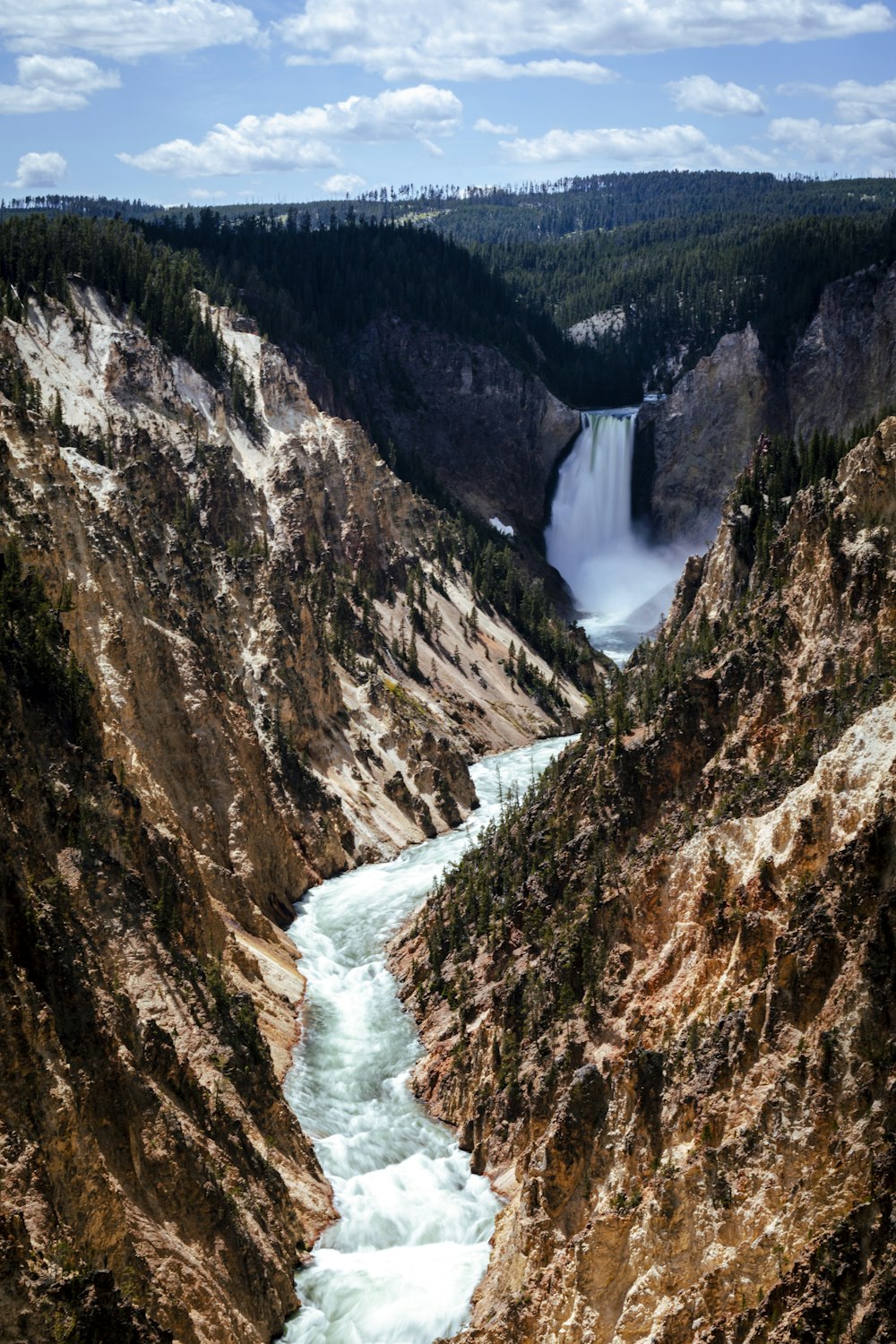 river between brown rocky mountains during daytime