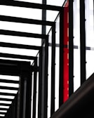 Industrial metal framework with a durable, glossy powder coating in bright red.