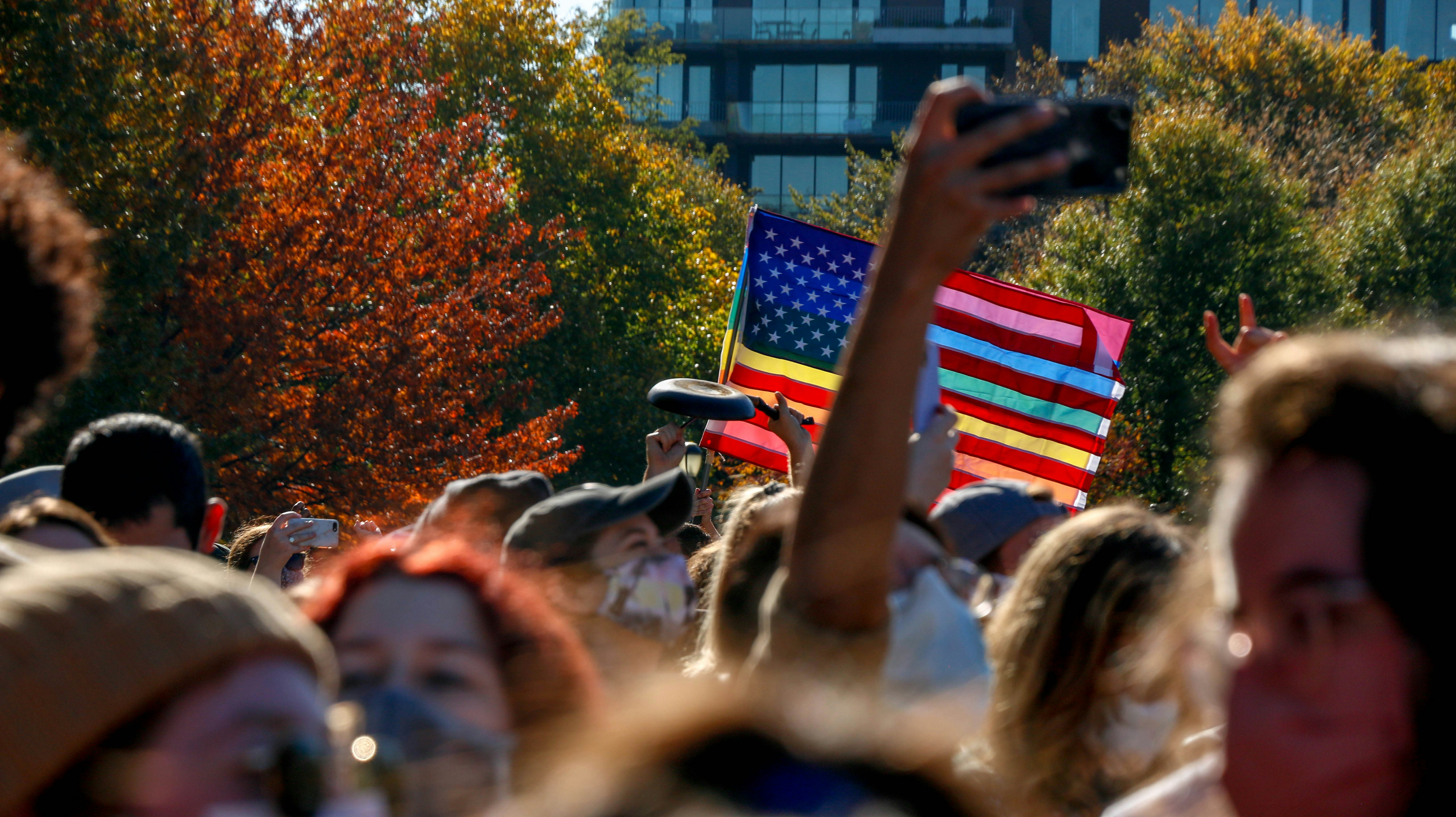people holding flag of us a during daytime
