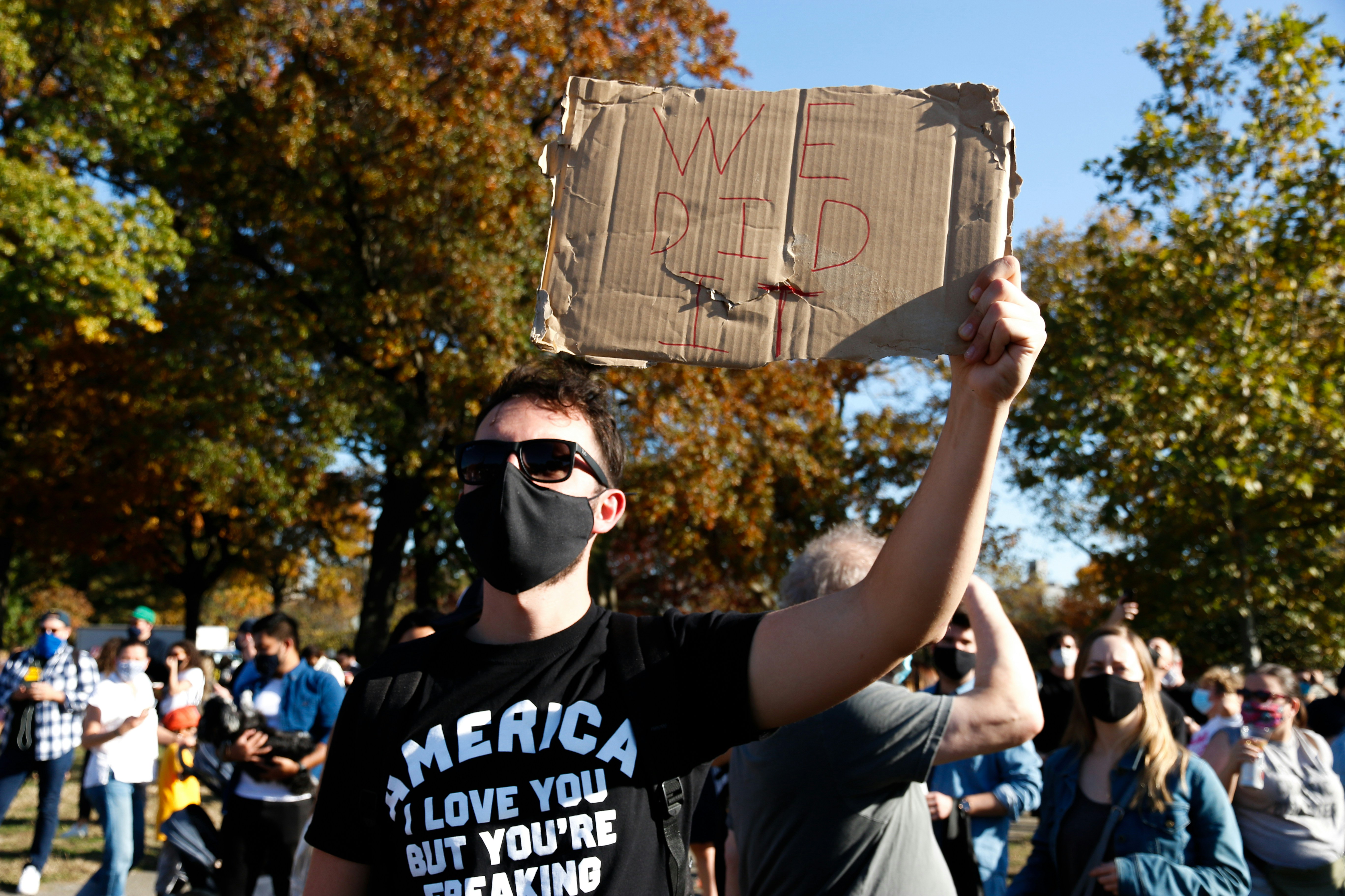 man in black crew neck t-shirt holding brown paper bag