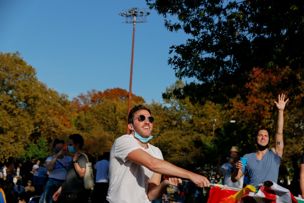 man in white shirt wearing black sunglasses