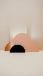 Geometric wall decor pieces arranged artistically on a neutral wall.