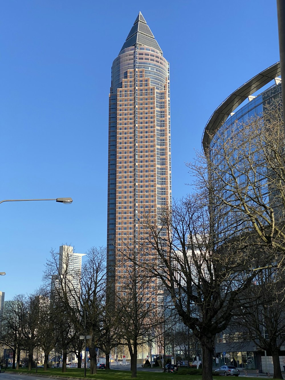 gray concrete building near trees during daytime