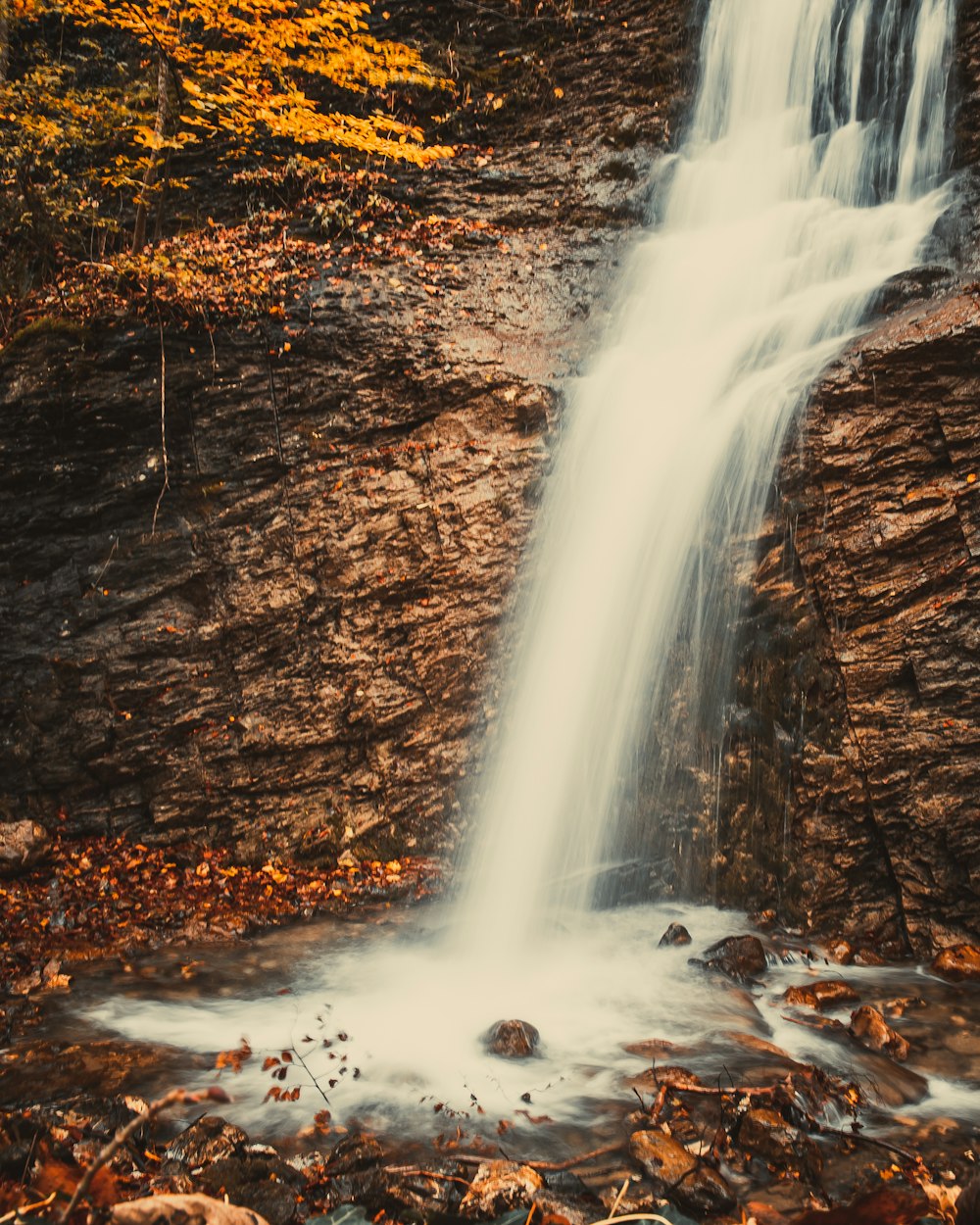 water falls on brown rocky ground