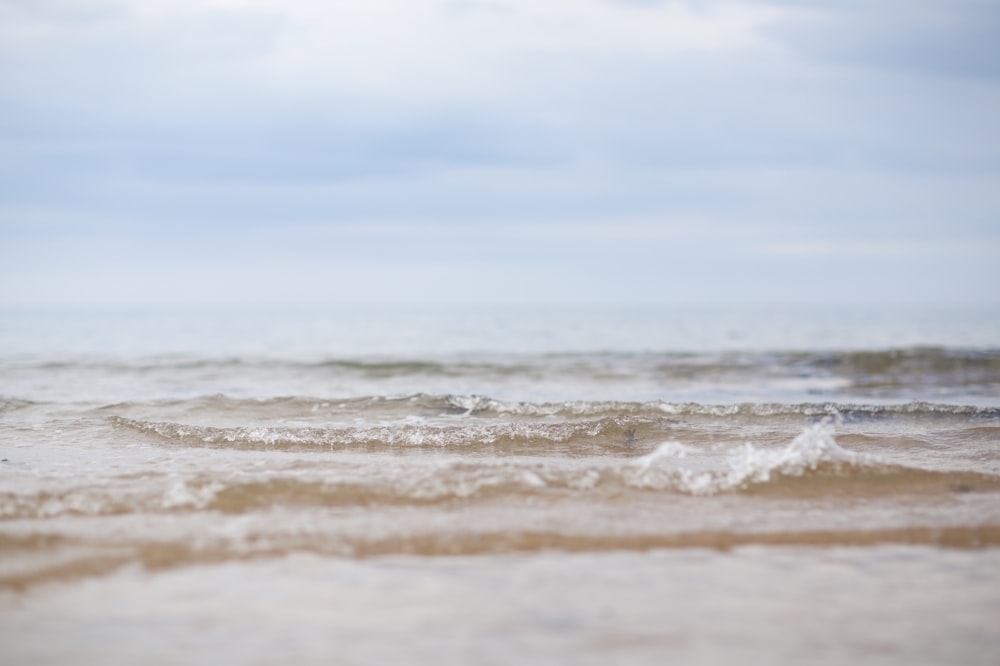 ocean waves under blue sky during daytime