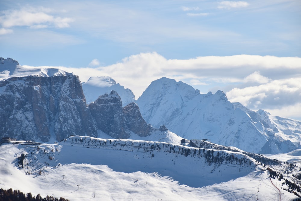 snow covered mountain under cloudy sky during daytime