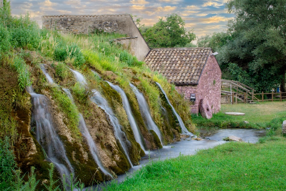 brown brick house near green grass field during daytime