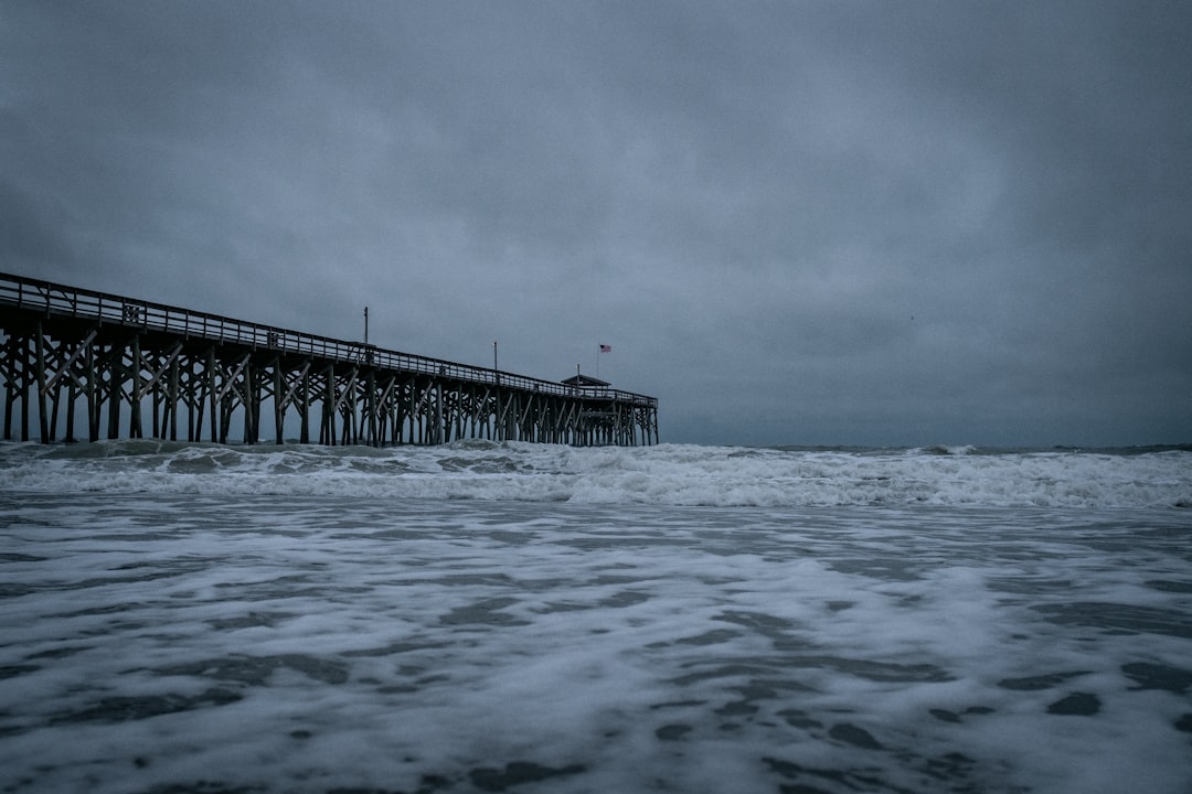 brown wooden dock on sea under white clouds, Storm blowing ashore