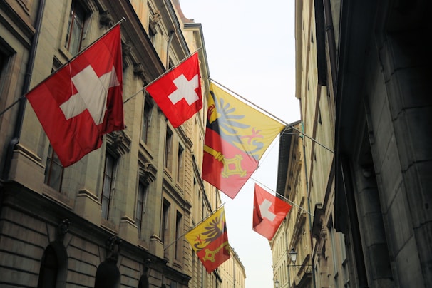 Swiss and Moldovan flags displayed side by side at the entrance of the Chamber of Commerce building.