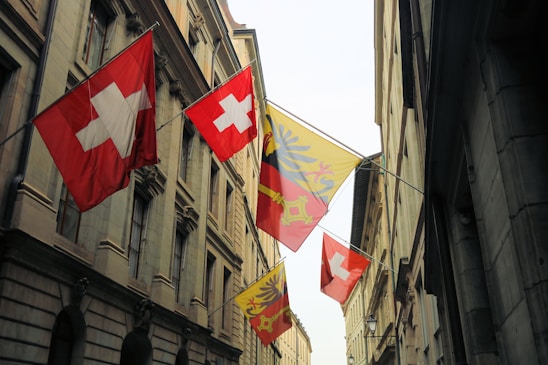 red white and yellow flags on flag pole