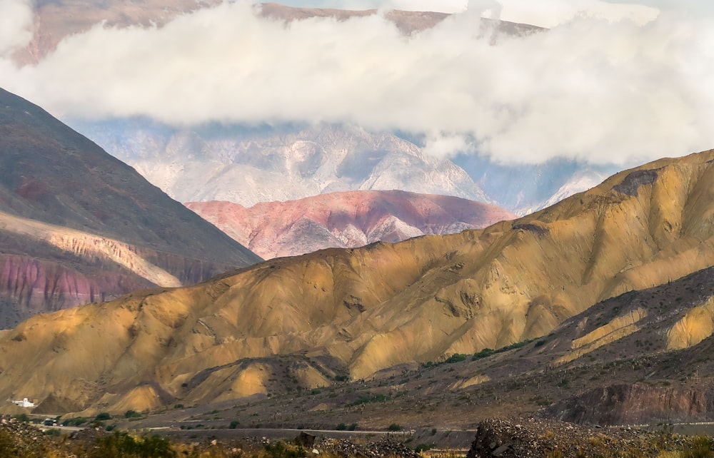 green and brown mountains under white clouds during daytime