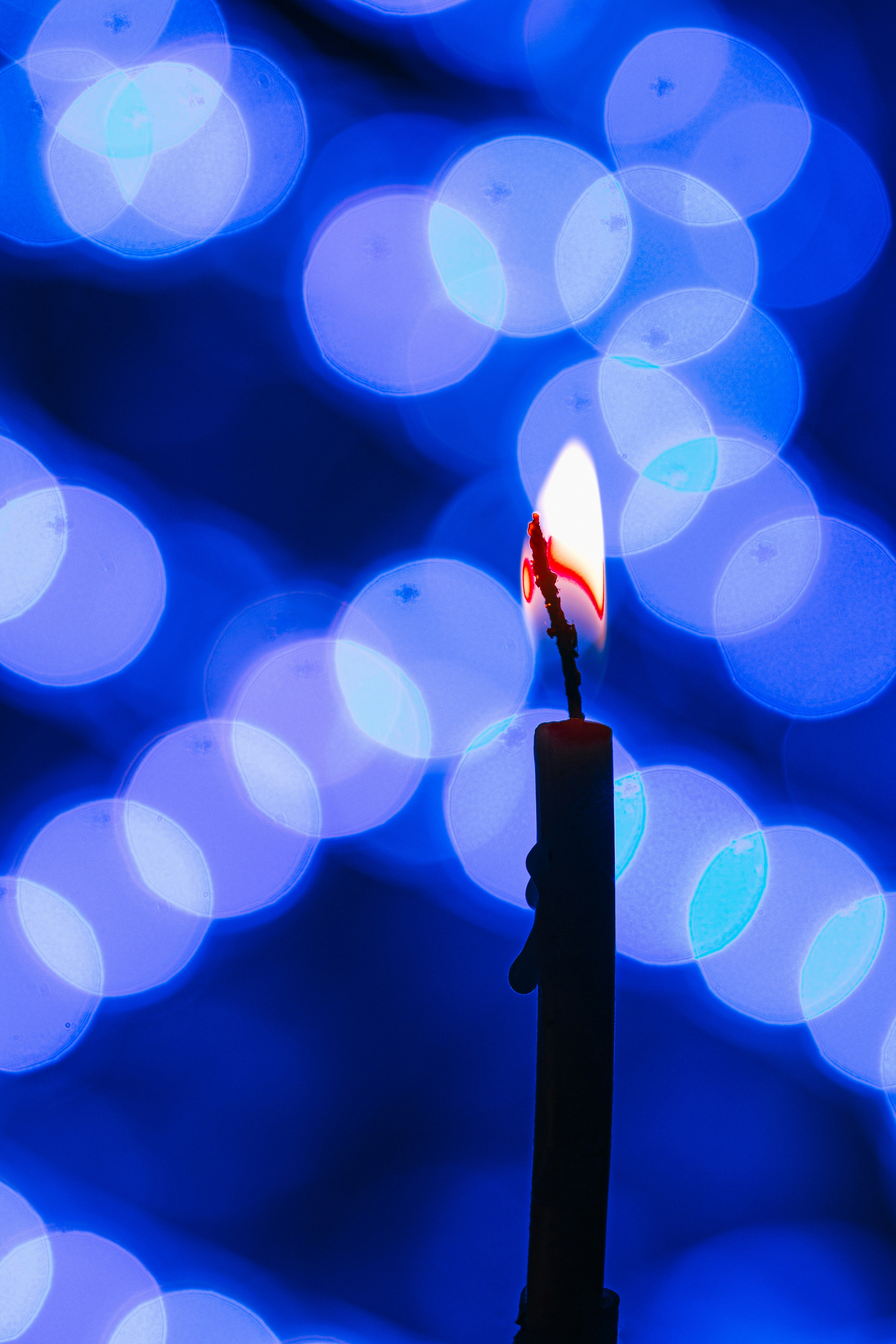 lighted candle in bokeh photography