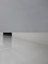 Minimalist epoxy floor design featuring black, white, and silver textures with golden highlights.