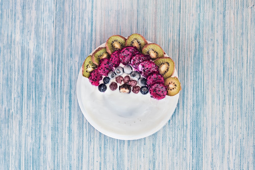 brown and green round fruit on white ceramic plate