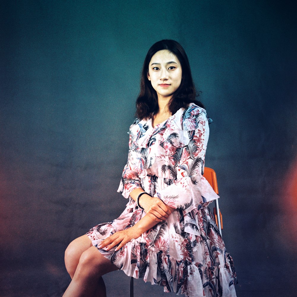 woman in white red and blue floral dress