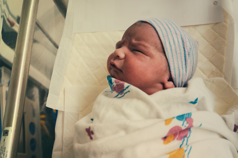 baby in white knit cap