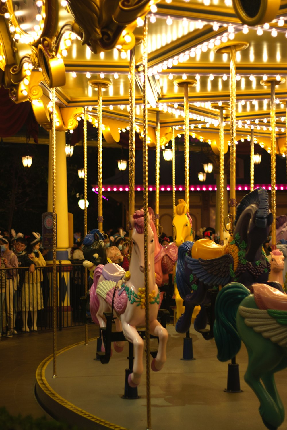 people riding on carousel during night time