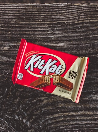 kitkat chocolate pack on black textile