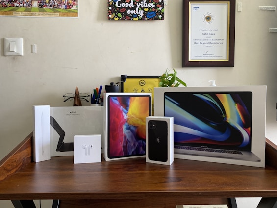 A diverse collection of software boxes arranged on a wooden desk.