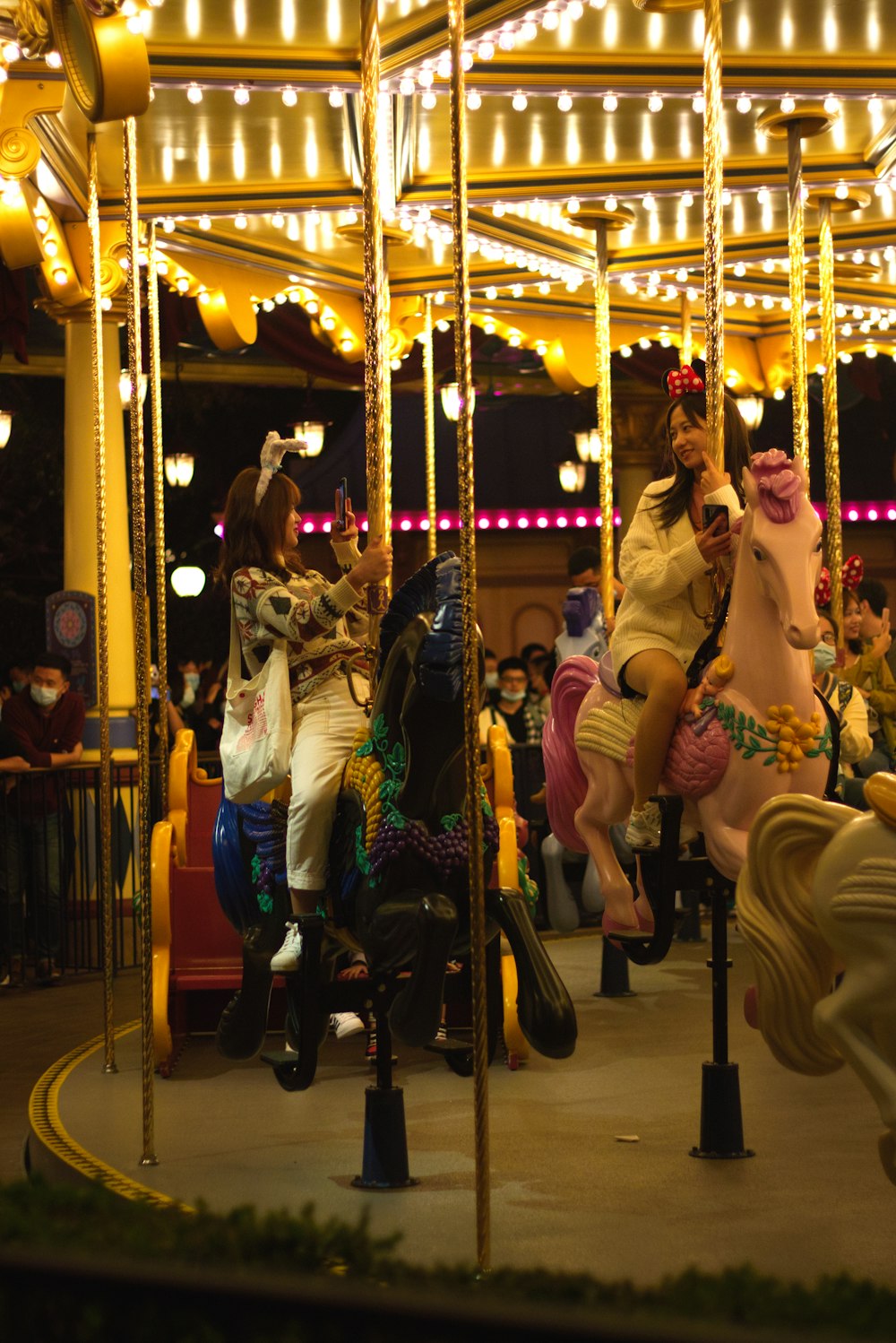 a group of people riding on a merry go round