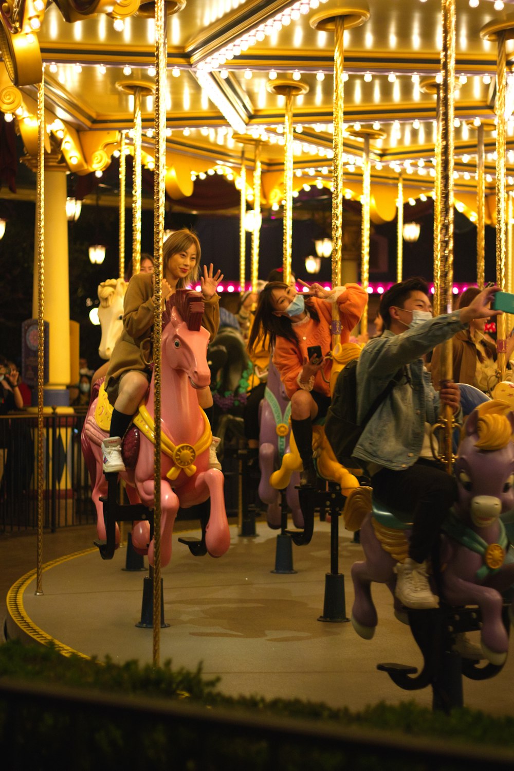 people riding on carousel during night time