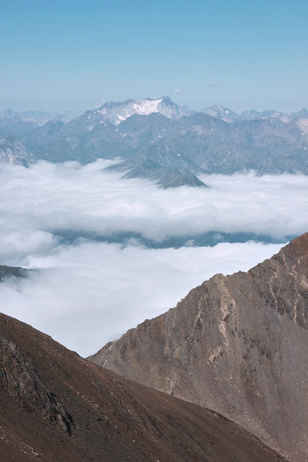 brown and gray mountains under white clouds during daytime