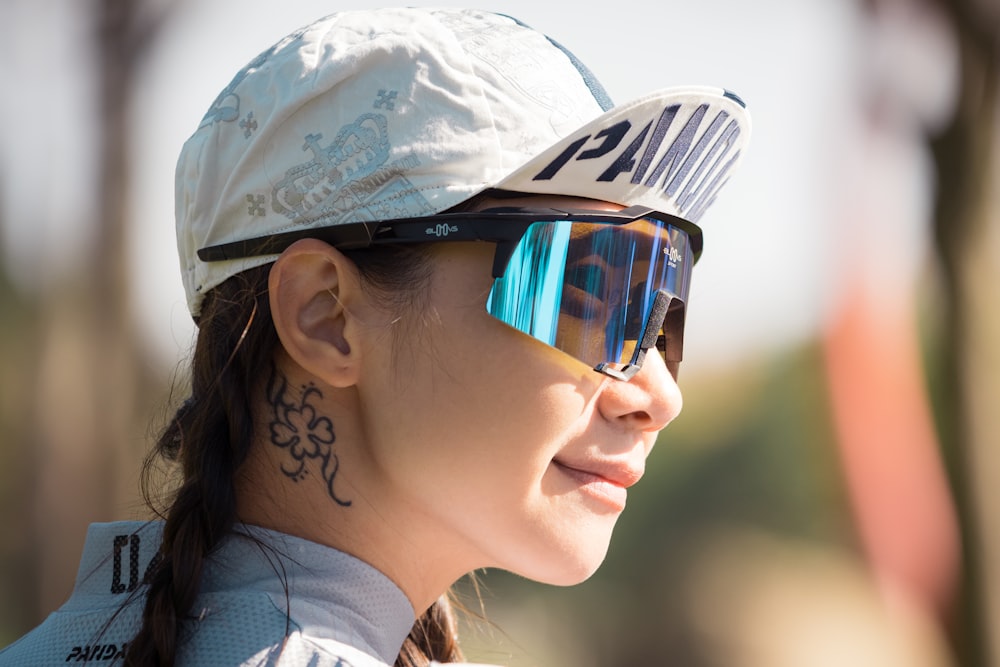 woman in white and gray camouflage cap and black sunglasses
