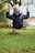 child in gray long sleeve shirt sitting on swing during daytime