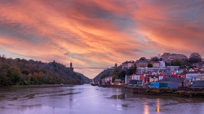 bridge over river during sunset