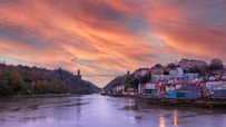 bridge over river during sunset